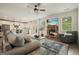 Open-concept living room showcasing a stone fireplace, TV, and a view into the modern kitchen at 6915 Rambling Vale, Cumming, GA 30028