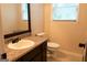 Well-lit bathroom with granite countertop, vanity, and large mirror at 8039 Woods Ln, Jonesboro, GA 30236