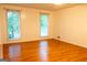 Bright bedroom with hardwood floors and natural light from two large windows at 8039 Woods Ln, Jonesboro, GA 30236