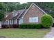 Attractive brick home with manicured bushes and a lush green lawn at 8039 Woods Ln, Jonesboro, GA 30236