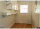 Storage room with white shelving, a window, and vinyl floors at 8039 Woods Ln, Jonesboro, GA 30236