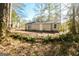 Backyard showing the back of the house with a wooded area at 8479 Alden Dr, Riverdale, GA 30274
