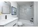 Bathroom featuring a vanity and bath with a shower and marble-style tile at 8479 Alden Dr, Riverdale, GA 30274