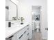 Bathroom showing double vanity with modern fixtures, with an attached additional bathroom at 8479 Alden Dr, Riverdale, GA 30274