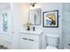 Bathroom featuring a vanity with modern fixtures, marble-style tile, and decor at 8479 Alden Dr, Riverdale, GA 30274
