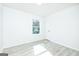Bedroom showing a bright, naturally lit space with light gray wood-look floors at 8479 Alden Dr, Riverdale, GA 30274