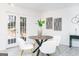 Bright dining area featuring a round table, modern chairs, and French doors leading to the outside at 8479 Alden Dr, Riverdale, GA 30274