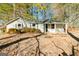 Charming single-story home featuring a covered porch and a well-maintained front yard with mature trees at 8479 Alden Dr, Riverdale, GA 30274