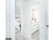 Hallway view looking into the bedroom and bathroom, with all-white modern decor at 8479 Alden Dr, Riverdale, GA 30274