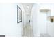 Hallway leading to various rooms, showing the bright and updated interior with consistent flooring at 8479 Alden Dr, Riverdale, GA 30274
