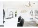 Stylish kitchen with white cabinetry, quartz countertops, and modern fixtures, flowing into the dining area at 8479 Alden Dr, Riverdale, GA 30274