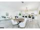 Open-concept living and dining area, with updated kitchen, modern furnishings, and natural light at 8479 Alden Dr, Riverdale, GA 30274