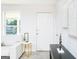 Bright living room with a large window and white walls providing a clean, modern aesthetic at 8479 Alden Dr, Riverdale, GA 30274