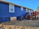 The exterior of a blue house features a wooden deck and a well-maintained yard at 95 Mccoy Dr, Carrollton, GA 30116