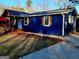View of the side of the house with the blue exterior and wooden shutters, along with a concrete driveway at 95 Mccoy Dr, Carrollton, GA 30116