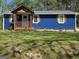 Charming home boasts a blue exterior with a cozy front porch, inviting curb appeal and mature trees at 95 Mccoy Dr, Carrollton, GA 30116
