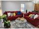 Inviting living room featuring hardwood floors, red sofas with throw pillows, and stylish decor at 95 Mccoy Dr, Carrollton, GA 30116