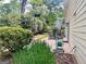 View of the backyard with a table, chairs, a hose reel, and green grass at 130 Floss Flower Ct, Roswell, GA 30076