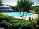 Community pool with diving boards, lifeguard stand, and clubhouse in a lush setting at 130 Floss Flower Ct, Roswell, GA 30076