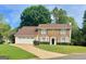 Charming two-story brick home with a manicured lawn and an attached two-car garage at 130 Floss Flower Ct, Roswell, GA 30076