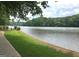 Lakeside view with lush greenery, offering a peaceful and scenic setting at 130 Floss Flower Ct, Roswell, GA 30076
