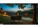 Scenic lake view featuring a bench, lush greenery, and tranquil water reflecting the sky at twilight at 130 Floss Flower Ct, Roswell, GA 30076