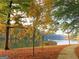 Scenic lake view with mature trees in fall colors and a well-maintained walking path at 130 Floss Flower Ct, Roswell, GA 30076