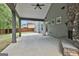 This back porch has a ceiling fan, stone fireplace and backyard access at 70 Pacific Ave, Sharpsburg, GA 30277