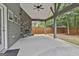 This back porch boasts a stone fireplace, ceiling fan and lovely view of the yard at 70 Pacific Ave, Sharpsburg, GA 30277