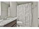 This bathroom features a vanity with granite counters and a shower with curtain at 70 Pacific Ave, Sharpsburg, GA 30277