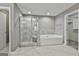Modern bathroom featuring a glass-enclosed shower, separate tub, and tile flooring at 70 Pacific Ave, Sharpsburg, GA 30277