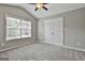 This bedroom features a ceiling fan and a double-door closet at 70 Pacific Ave, Sharpsburg, GA 30277
