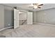 Bright and airy bedroom features a ceiling fan and open doorway leading to the landing at 70 Pacific Ave, Sharpsburg, GA 30277