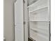 Bedroom closet featuring custom built-in shelving and storage space at 70 Pacific Ave, Sharpsburg, GA 30277