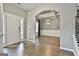 Inviting foyer with hardwood floors leading to a formal dining room with coffered ceilings and an elegant light fixture at 70 Pacific Ave, Sharpsburg, GA 30277
