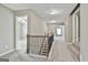 Well-lit carpeted hallway with iron railing, leading to various rooms within the home at 70 Pacific Ave, Sharpsburg, GA 30277