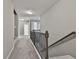 Hallway with carpet, wood railing and multiple rooms at 70 Pacific Ave, Sharpsburg, GA 30277