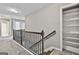 Upstairs hallway with carpet, decorative railing, and a closet at 70 Pacific Ave, Sharpsburg, GA 30277