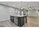 Spacious kitchen featuring a granite island, stainless steel appliances, and hardwood flooring at 70 Pacific Ave, Sharpsburg, GA 30277