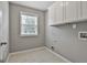 This laundry room features tile floors, a window, and overhead cabinets at 70 Pacific Ave, Sharpsburg, GA 30277