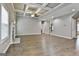 Large living room features a fireplace, coffered ceiling, and easy access to other areas of the home at 70 Pacific Ave, Sharpsburg, GA 30277