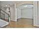 Living area adjacent to stairs and dining area with hardwood floors and arched doorway at 70 Pacific Ave, Sharpsburg, GA 30277