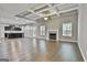 Expansive living room boasts coffered ceilings, a fireplace, and an open layout with the kitchen at 70 Pacific Ave, Sharpsburg, GA 30277