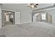 Expansive carpeted main bedroom with tray ceiling, ceiling fan, and view to hall at 70 Pacific Ave, Sharpsburg, GA 30277