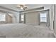 Large carpeted main bedroom featuring a ceiling fan, recessed lights, and multiple windows at 70 Pacific Ave, Sharpsburg, GA 30277