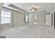 Bright main bedroom features recessed lighting, a fan, and windows for natural light and a glimpse of the bathroom at 70 Pacific Ave, Sharpsburg, GA 30277