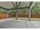Covered patio with stained support beams overlooking backyard at 70 Pacific Ave, Sharpsburg, GA 30277