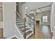 Elegant staircase with wooden steps, iron spindles, and access to the open-concept living area at 70 Pacific Ave, Sharpsburg, GA 30277