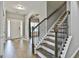 Elegant staircase featuring hardwood steps, dark wood handrail and metal spindles at 70 Pacific Ave, Sharpsburg, GA 30277