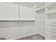Spacious walk-in closet with built-in shelves and drawers for organized storage at 70 Pacific Ave, Sharpsburg, GA 30277